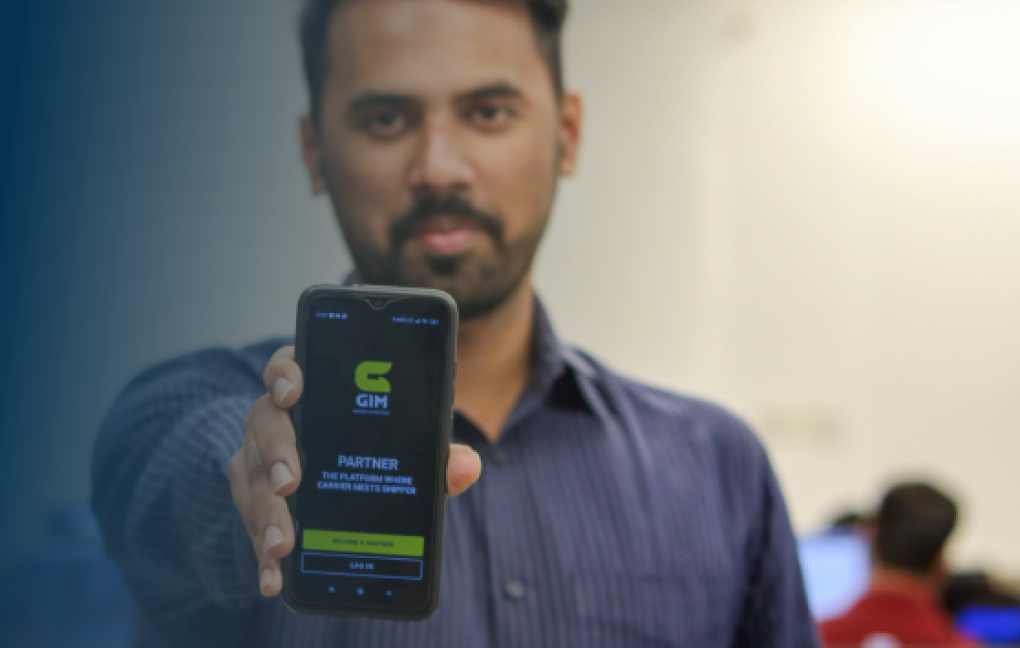 A GIM user holding the app